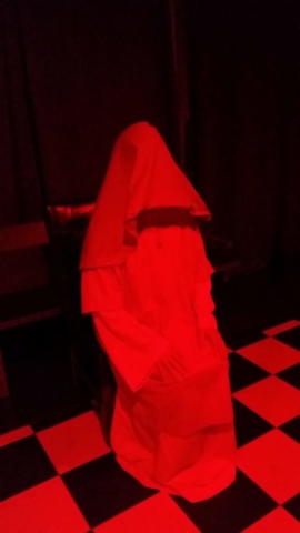 seated hooded ritualist
