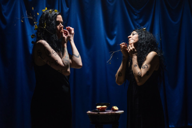 two women sensuously eating the apple pieces
