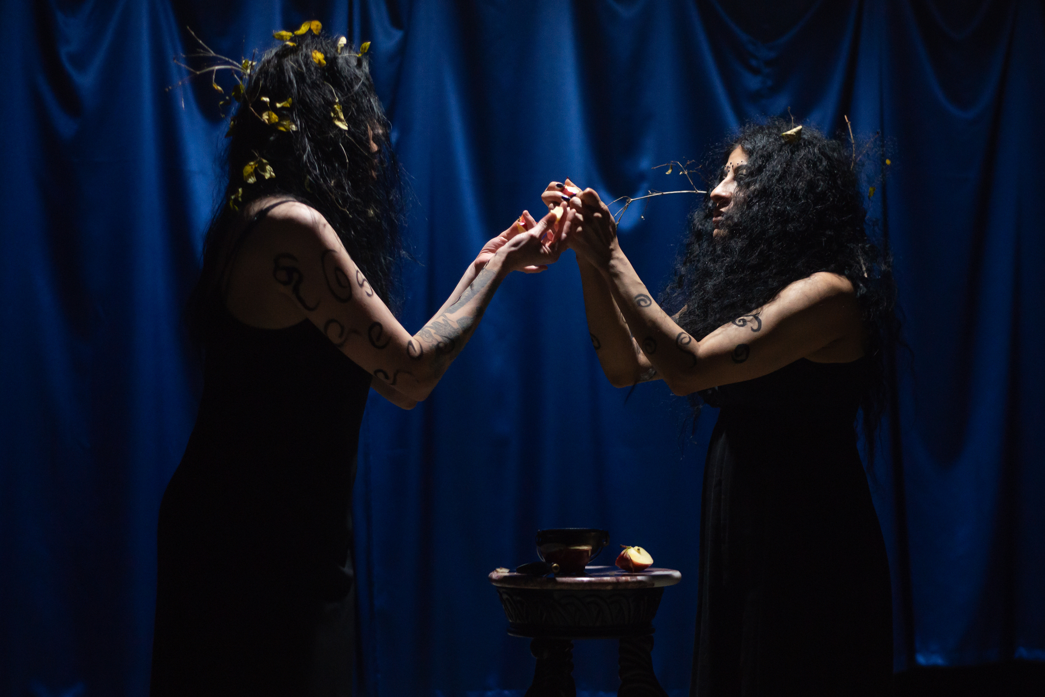 two women holding pieces of the cut up apple